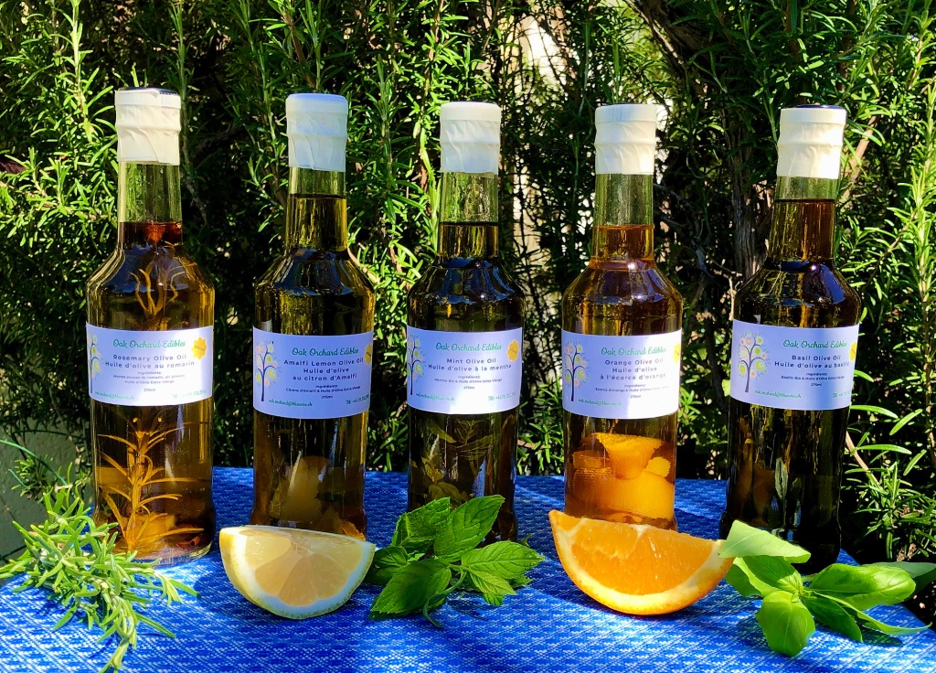 Six bottles of artisanal olive oil in different flavours.