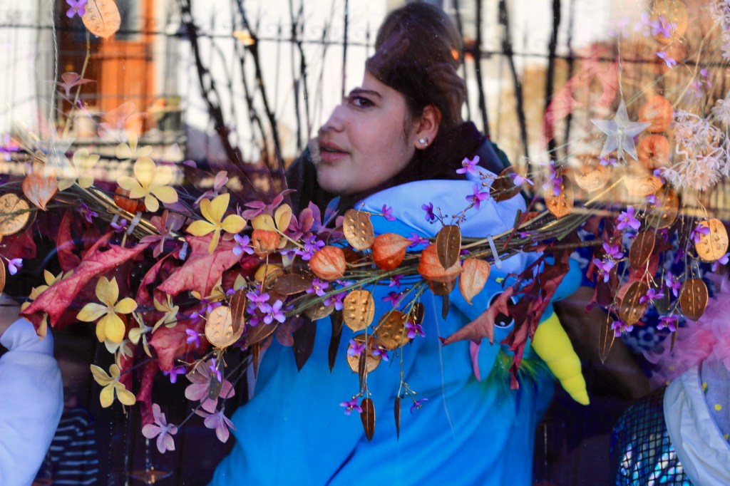 A woman staring out from a restaurant window.