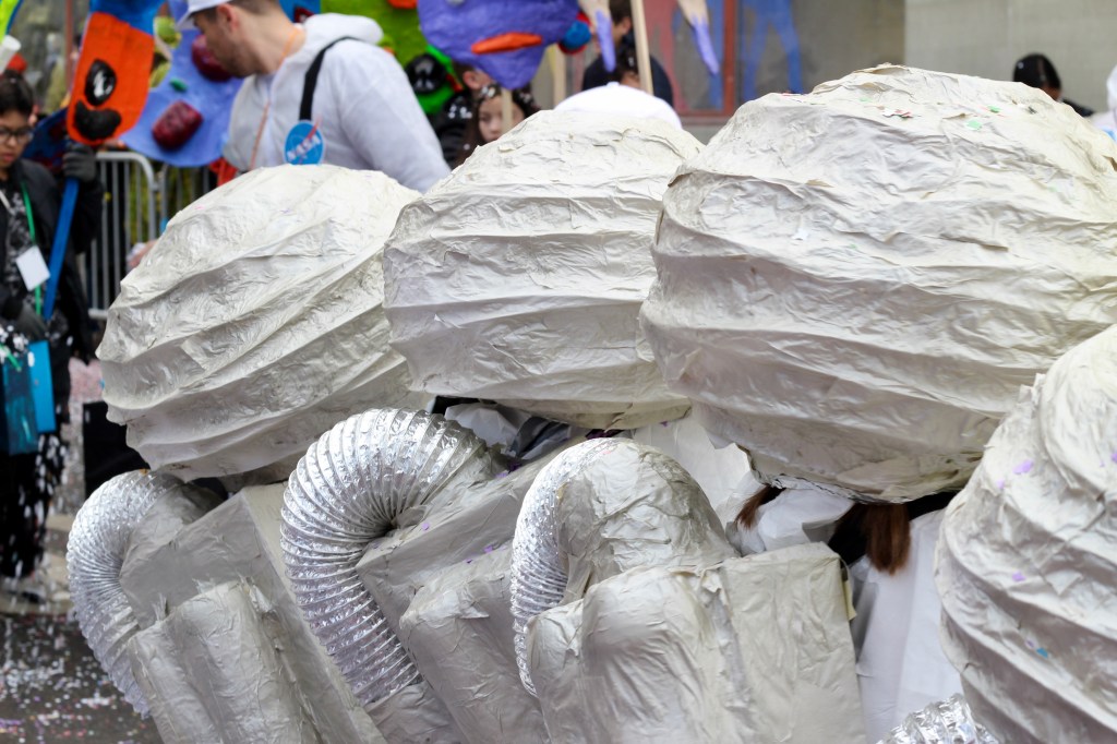 The back view of three children dressed in homemade costumes  as NASA astronauts.