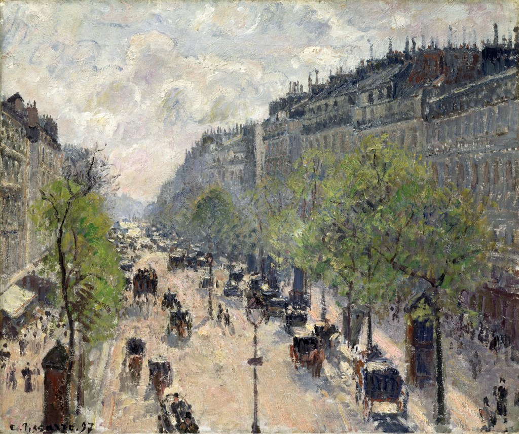 A busy Parisian street with high buildings on either side and horse carriages and people hurrying by. 